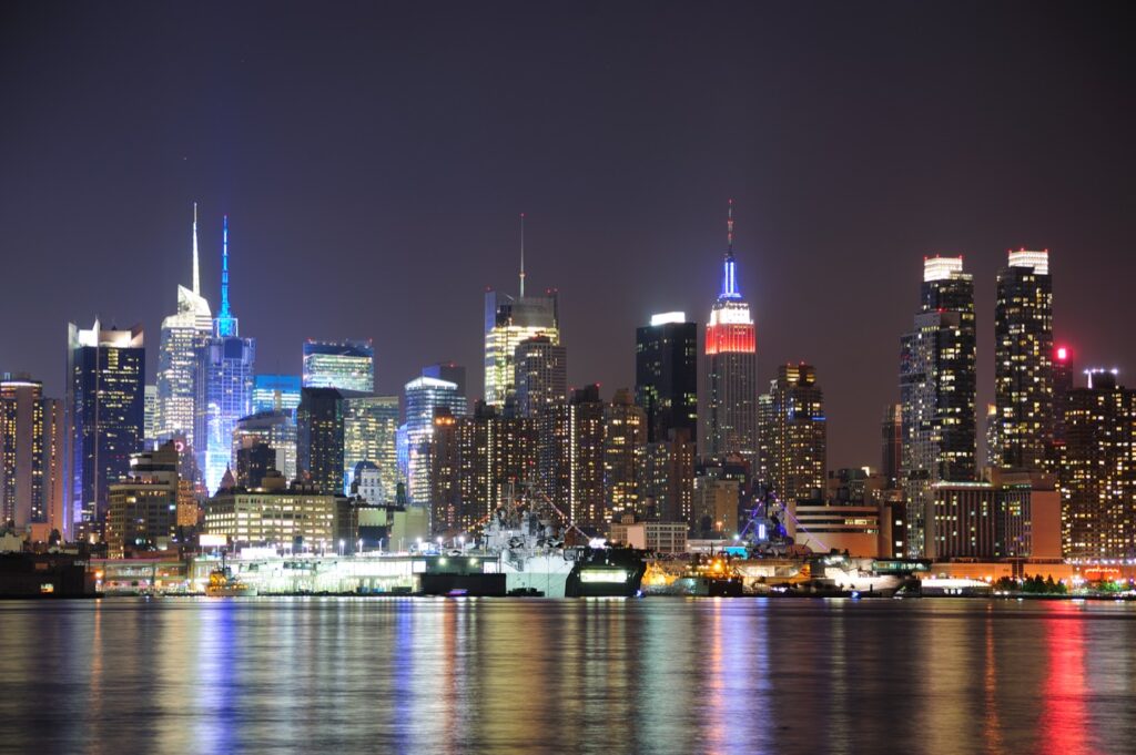 Manhattan skyline at night seen across the water